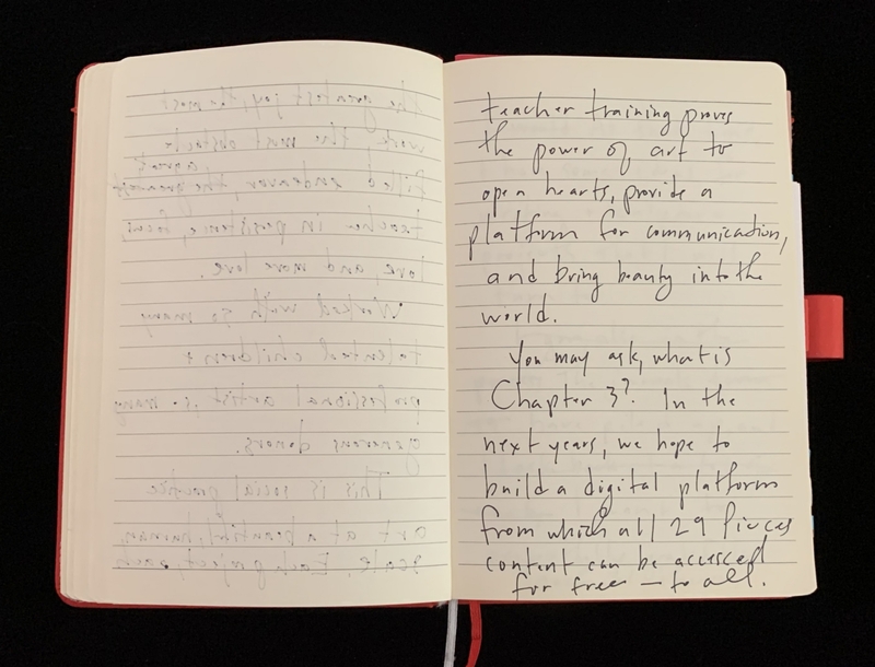 An open notebook with cursive handwriting on both visible pages.