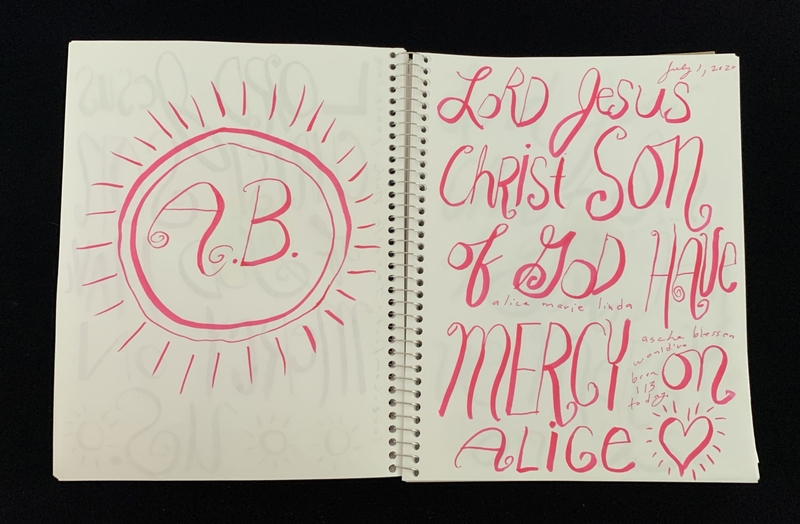 A handwritten page featuring a monogram and a prayer, with decorative elements and a date.