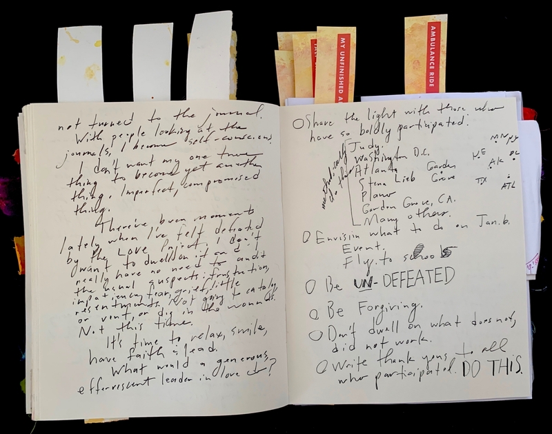 An open journal with handwritten text and colored tabs at the top.