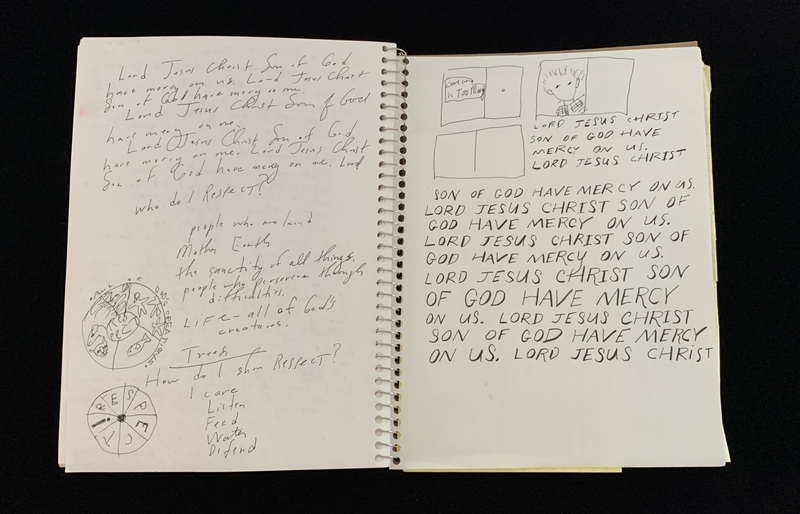 A handwritten notebook page with religious and philosophical content, featuring sketches and repetitive prayers.