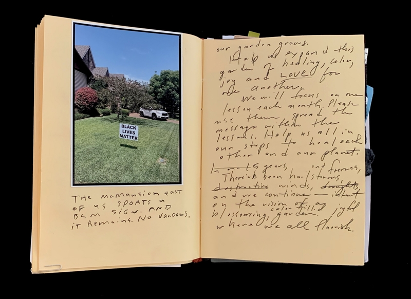 A handwritten page with a photograph of a lawn featuring a "Black Lives Matter" sign, accompanied by a note about a nearby mansion.