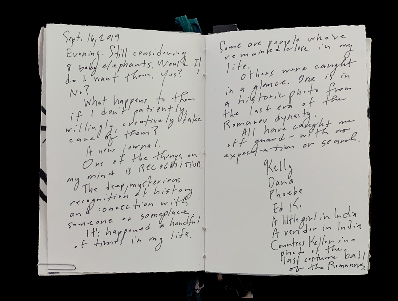 Open notebook with handwritten text on both pages.