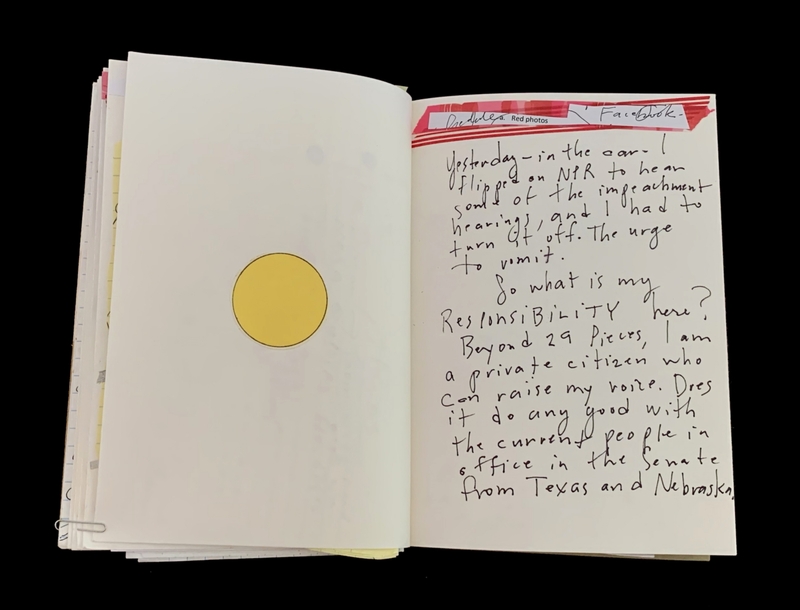 Open book with a yellow circle on the left page and handwritten text on the right page.