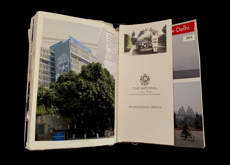 Open pages of a book with a building mural and The Imperial Hotel information.