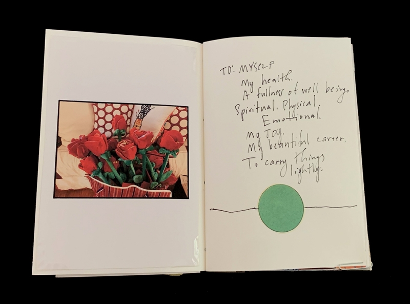 Open book showing a photo of red roses on the left and handwritten notes on the right with a green circle.