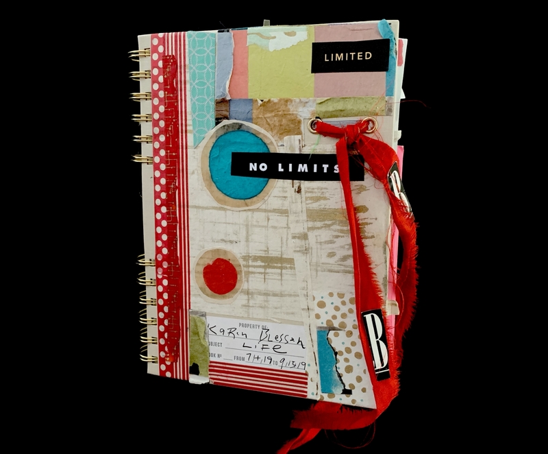 A creatively decorated journal with various patterns, ribbons, and text elements.