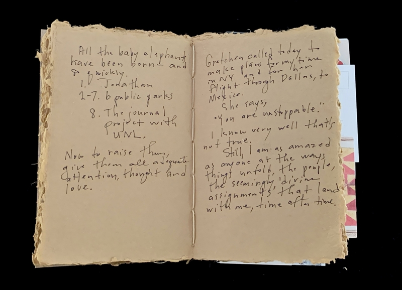 Open notebook with handwritten text on each page.
