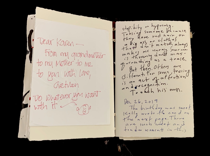 An open notebook with personal handwritten messages in red, black, and blue ink.