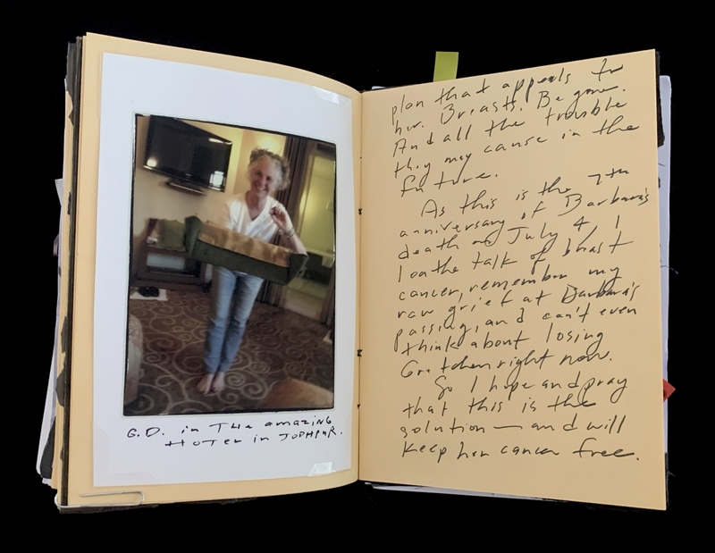A handwritten note and a Polaroid photo of a smiling person in a hotel room.