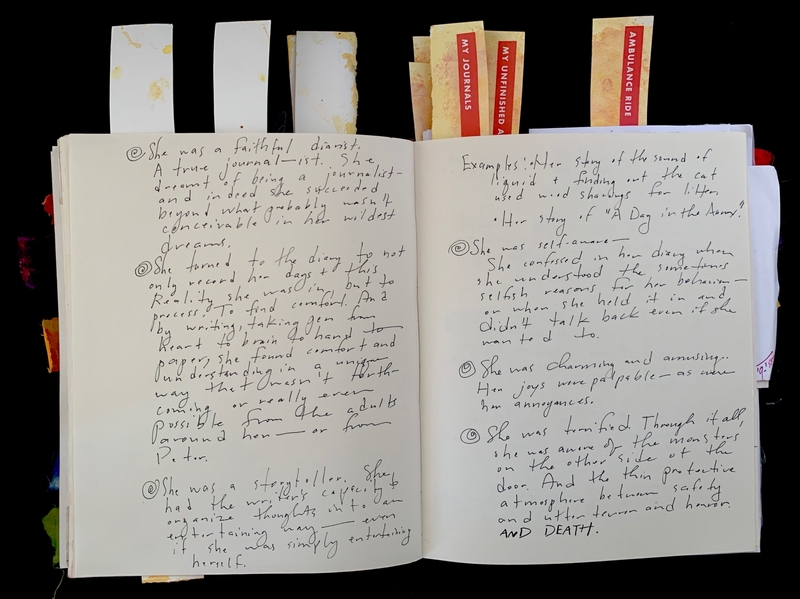 Open journal with handwritten text and bookmarks labeled "MY JOURNALS," "MY UNFINISHED ADVENTURE," and "AMBULANCE RIDE."