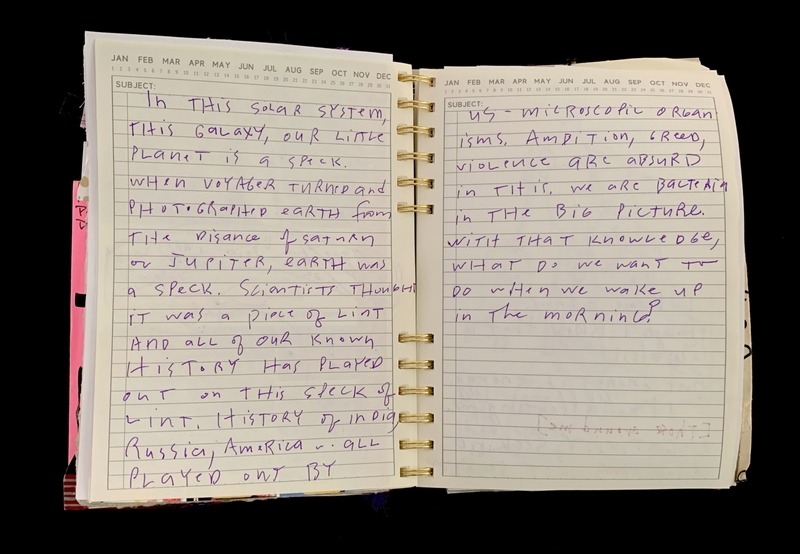 A handwritten page from a notebook discussing the insignificance of Earth in the solar system and broader cosmic context.