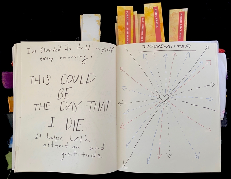 Open journal with handwritten text and a heart illustration with radiating arrows.