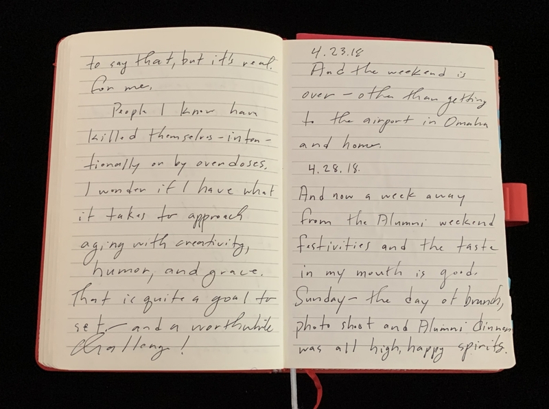 Open notebook with handwritten cursive text about life reflections and dated entries.