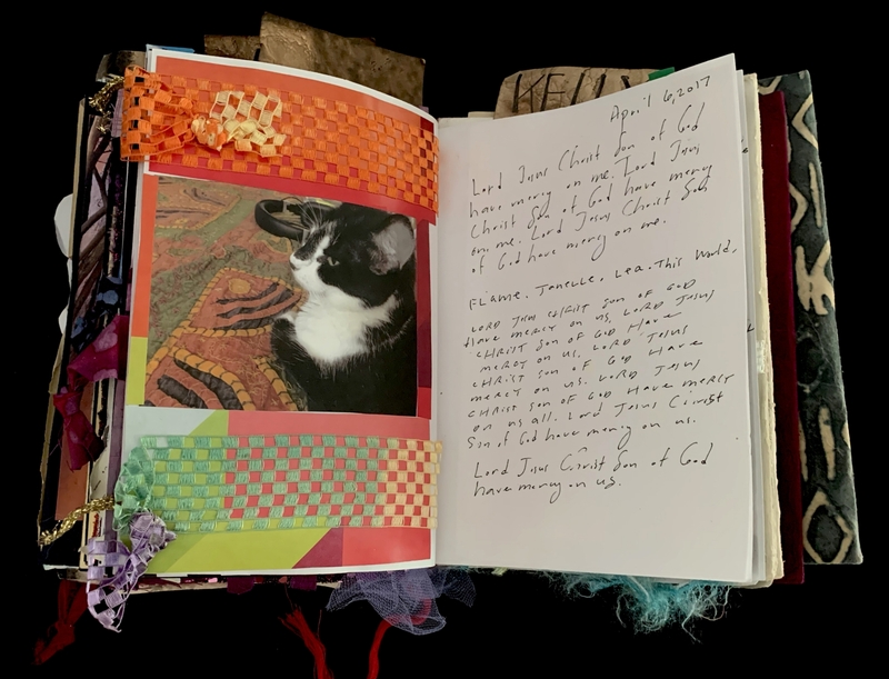 A scrapbook page featuring a photograph of a black and white cat, surrounded by colorful woven patterns and handwritten text.
