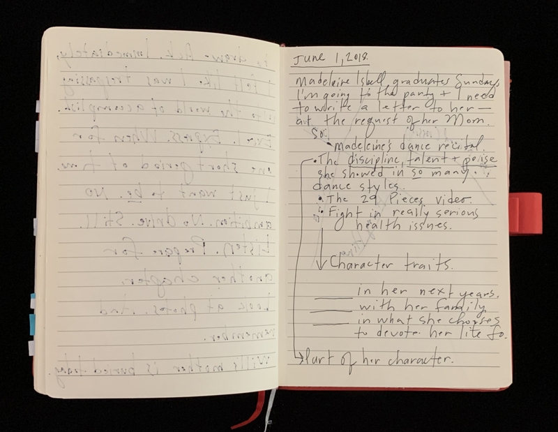 Open notebook showing handwritten entries on lined pages.