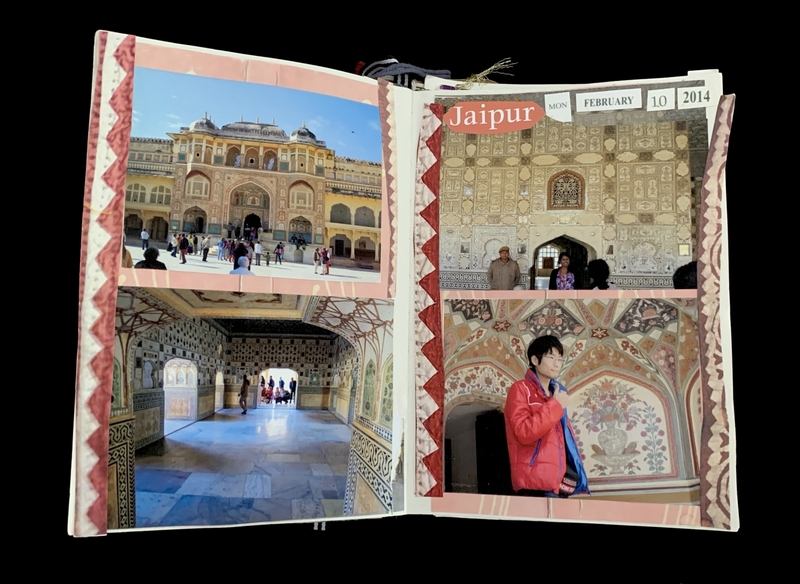 Scrapbook spread with photos of a historic building and decorated interiors from Jaipur.