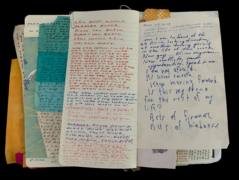 Open notebook with handwritten notes in various colors on multiple pages.