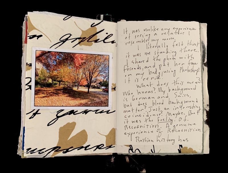 Open notebook with an autumn photo and cursive handwritten text.