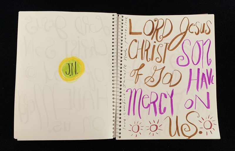 A page from a notebook featuring a handwritten prayer and a circular doodle.