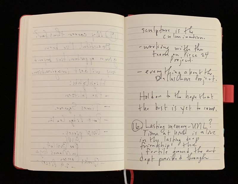 Open notebook with handwritten notes, partially upside down.