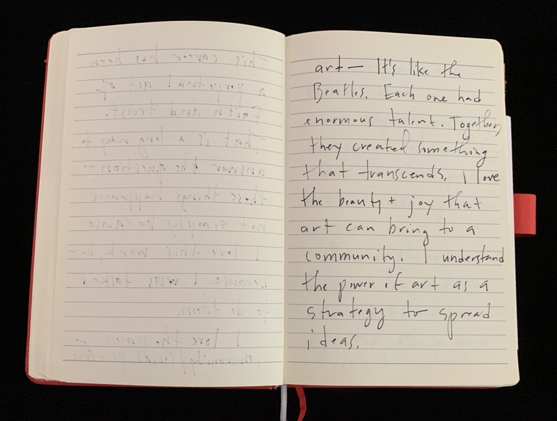 Open notebook with handwritten text on the right page and indented impressions on the left page.