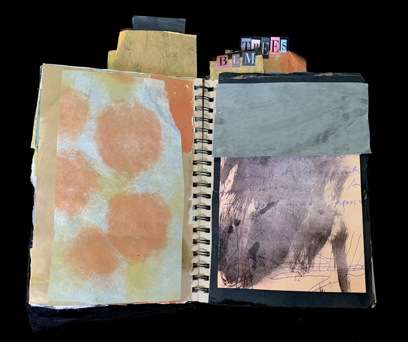 A mixed-media art piece featuring a spiral-bound notebook with various textures and colors, including a painted page with orange circles and a sketch of a tree.