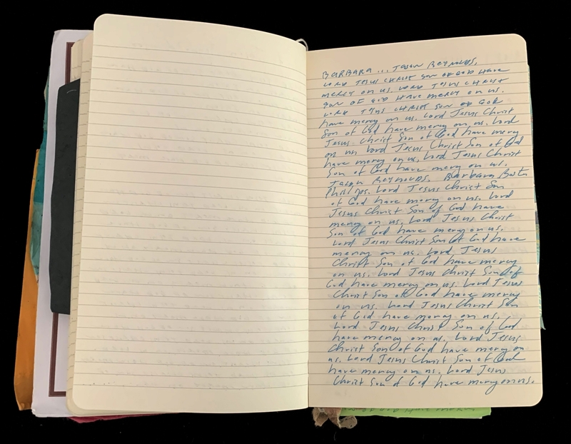 An open notebook with handwritten cursive text on one page.