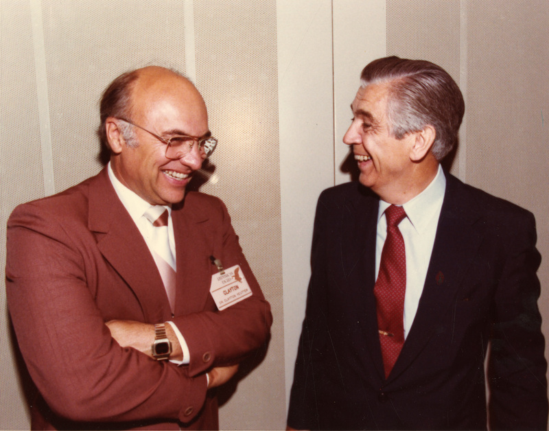 Clifford Hardin and Clayton Yeutter stand together laughing.