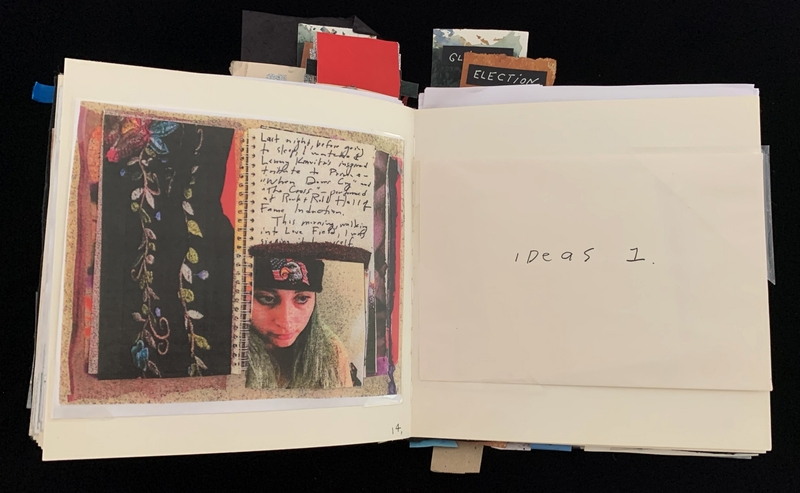 Open book with mixed-media art and handwritten notes on the left; "Ideas 1." written on the right.