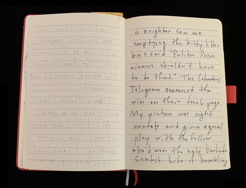 An open notebook with handwritten text on both pages; text on the right page is legible.