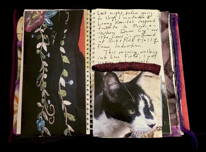 A journal page featuring a handwritten note, a photograph of a black and white cat, and a decorative fabric panel.