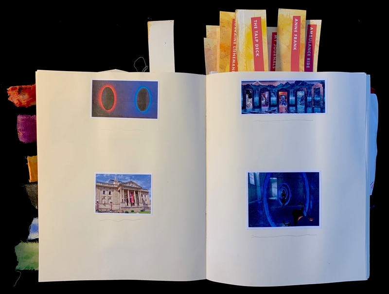 Open journal with artwork and labeled tabs protruding from the pages.