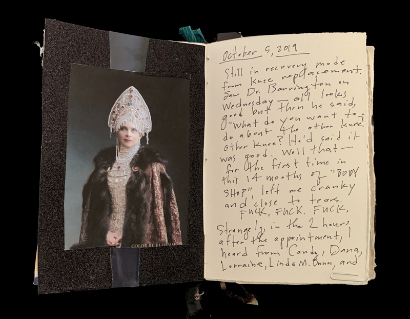 Open notebook showing a photo of a woman in a headdress and handwritten text on the opposite page.