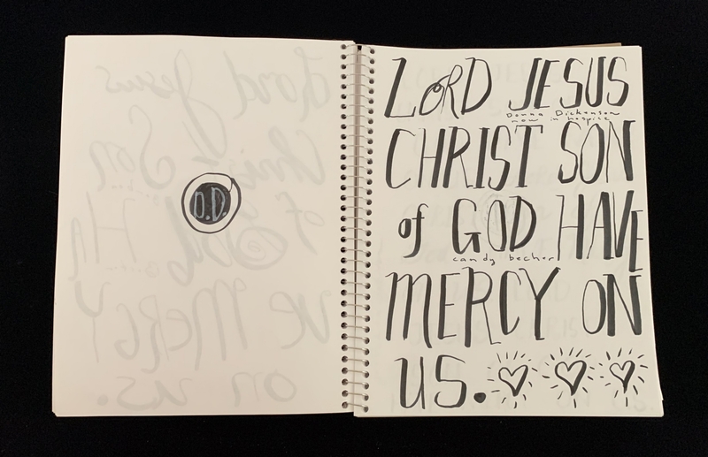 A handwritten prayer page featuring a bold, calligraphic inscription and decorative elements.