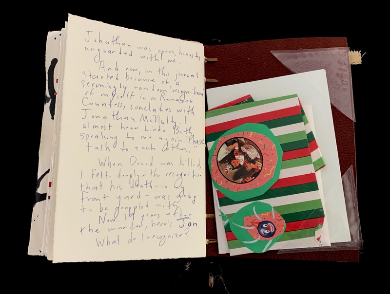 Open journal with handwritten text, colorful striped sheets on the right.