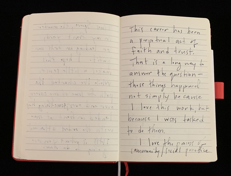 An open notebook with handwriting on both pages.