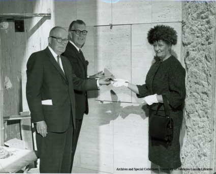 Isamu Noguchi on stairs with his commissioned sculpture, Song of the Bird.