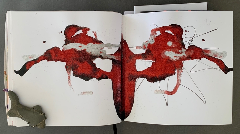 A vibrant, abstract drawing in red and white dominates the spread of a journal page.