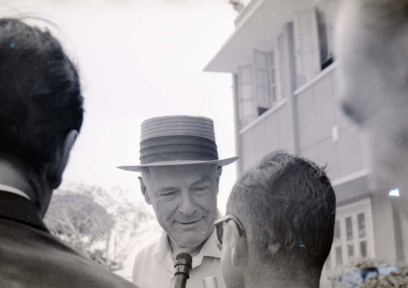 Henry Cabot Lodge Jr is stopped by a reporter with a microphone.