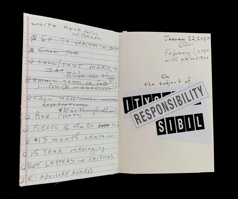 An open notebook showing handwritten notes on the left and printed text with stickers on the right.