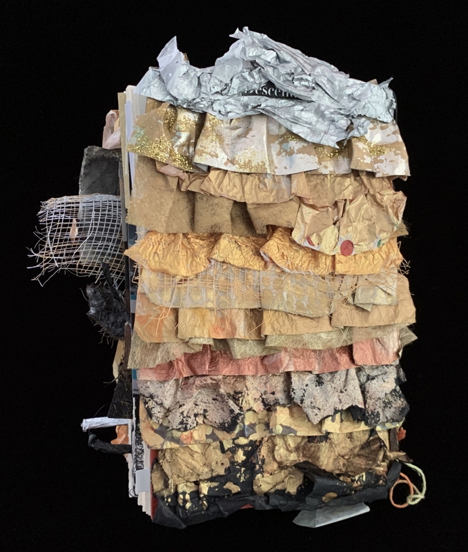 A layered, textured assemblage of paper and fabric, featuring a variety of colors and textures, creating a visually complex and abstract composition.