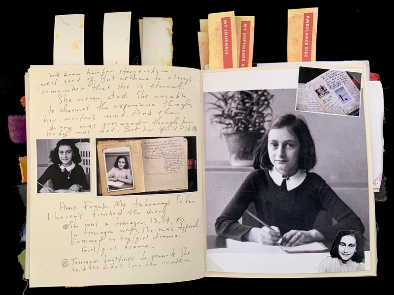 Open journal with photos and handwritten text about a young girl, with colorful tabs protruding from the top.