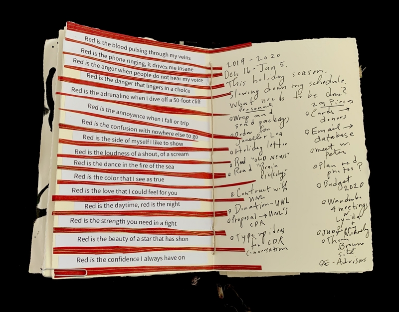 Open notebook with text strips on the left page and handwritten notes on the right page.