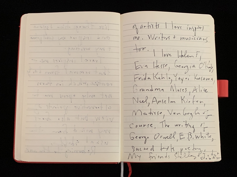 Open notebook with handwritten names in black ink on the right page, with a red bookmark.