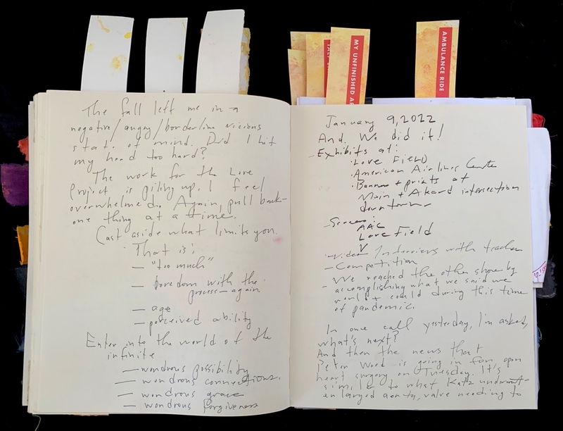 Open journal with handwritten text and colorful tabs.