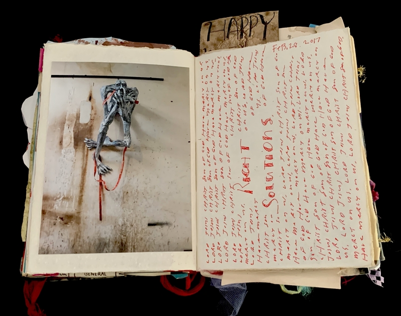 A page from a mixed-media art journal featuring a photograph of a skeletal figure and handwritten text.