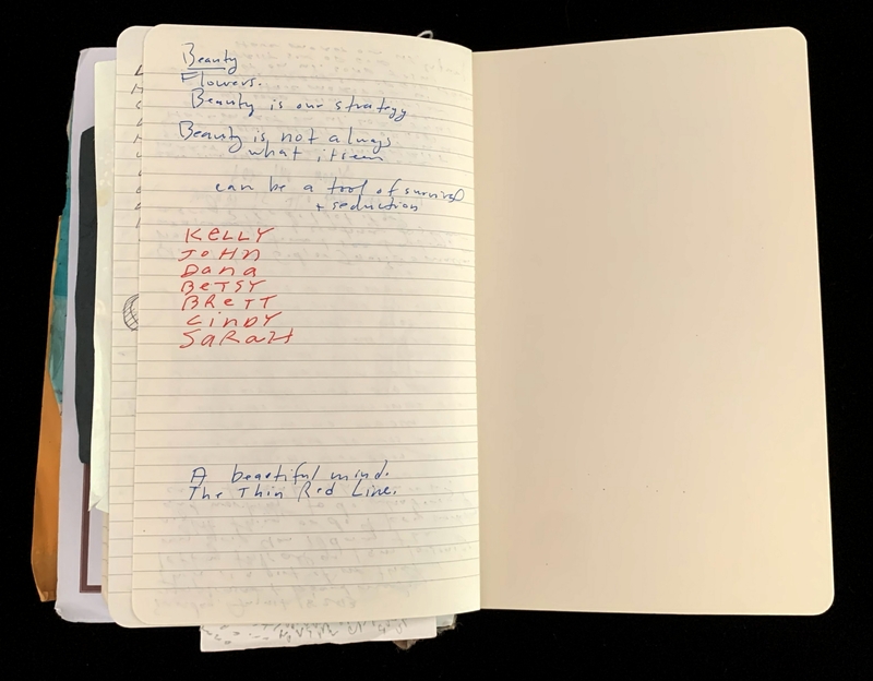 Open notebook with handwriting on one page.