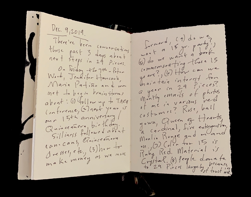 Open book with handwritten cursive notes about organizational brainstorming and anniversary celebrations.