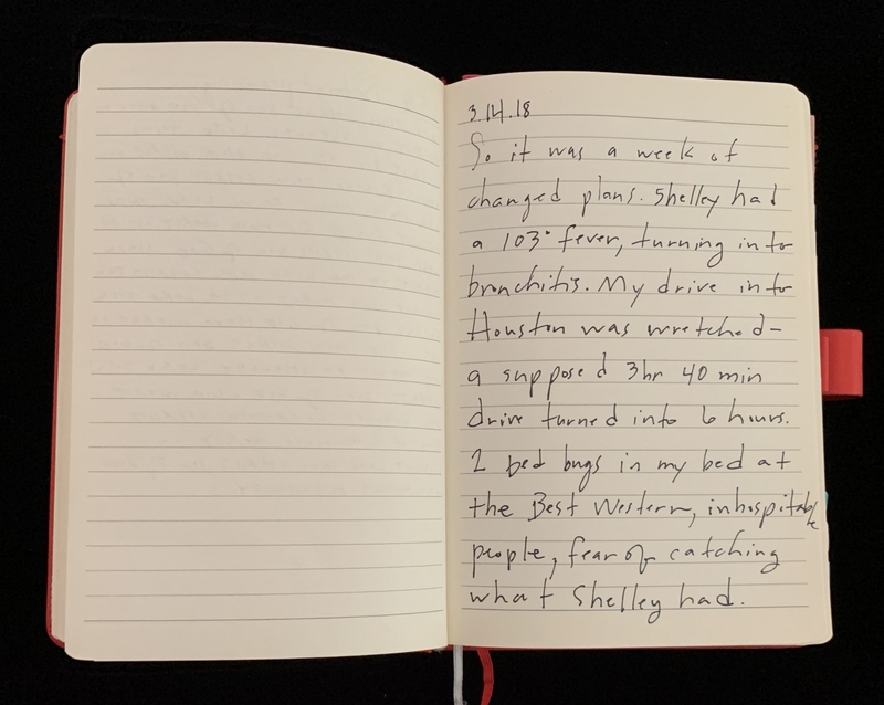 Open notebook with handwritten text on the right page dated 3.14.18.