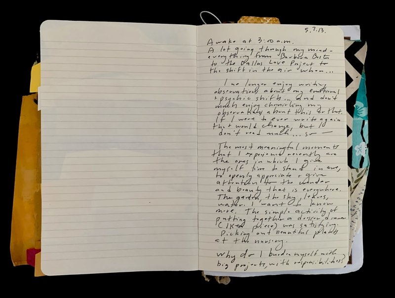 An open notebook with handwritten text on one page and a blank lined page opposite.